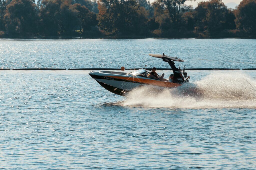 High-speed motorboat cuts through water on a sunny day, Immenstaad, Germany.